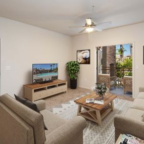 Open concept living area with ceiling fan and patio