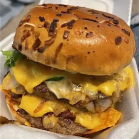 Close up of a custom double cheeseburger at Taystee's in Dearborn