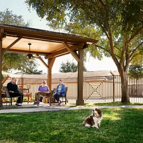 Private onsite fenced dog park with covered seating area