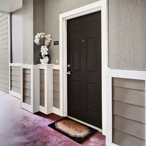 Apartment entrance with door bell and welcome mat