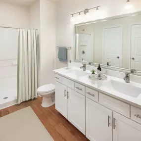 Neighborhood one bathroom with walk in shower wood look flooring and framed mirror