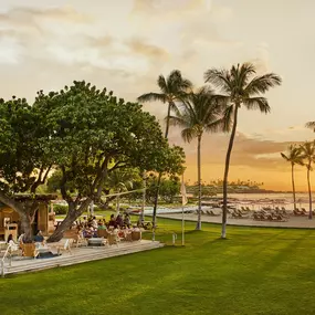 Lawn and open-air lounge at sunset near the Surf Shack.