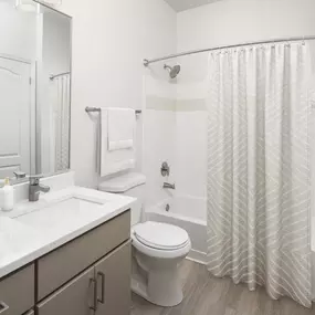 Luxury bath with quartz countertop and garden bathtub at Camden Westwood apartments in Morrisville, NC