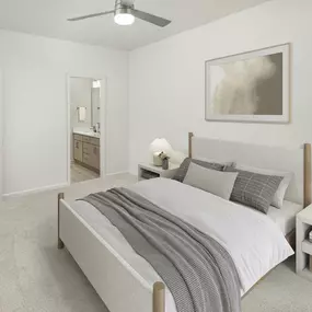 Bedroom with lighted ceiling fan and ensuite bath at Camden Westwood apartments in Morrisville, NC