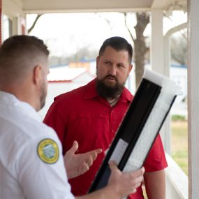 Duct cleaning service technician going over details with a customer in the Dallas, TX area.