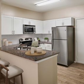 Spacious kitchens with granite countertops and stainless steel appliances at Camden Denver West Apartments in Golden, CO