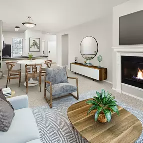 Open-concept living room with a fireplace Kitchen Camden Denver West Apartments in Golden, CO