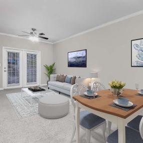 Dining and living area with private balcony, ceiling fan, and carpet flooring
