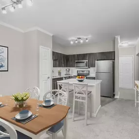 Dining area and kitchen with track lighting and white crown molding