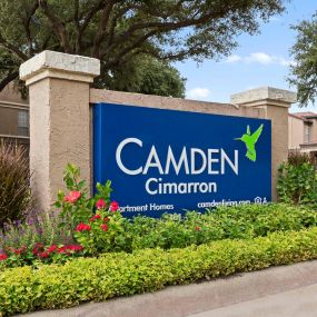 Front entry with logo sign at Camden Cimarron