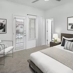 Renovated bedroom with balcony and ensuite bathroom at Camden Cimarron apartments in Irving, Tx