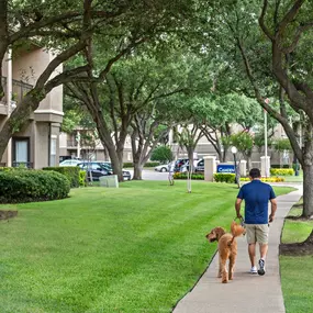 Resident walking their dog at the community