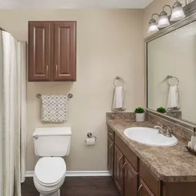 Bathroom with spacious countertop, cabinet storage and bathtub at Camden Cimarron