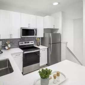 Renovated kitchen with private staircase entry to garage at Camden Cimarron apartments in Irving, Tx