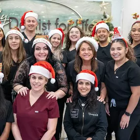 As you enter the reception area, you'll be greeted by a dazzling display of twinkling lights and vibrant decorations, transforming the space into a merry oasis. The reception desk is adorned with a festive wreath, and the friendly staff is dressed in festive attire, spreading cheer to every patient who walks through the door.