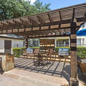 Poolside cabana with grills and seating at Camden Legacy Park apartments in Plano, TX
