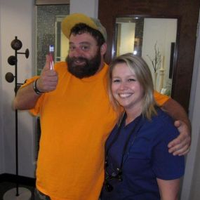 Happy client gives a thumbs sup after successful appointment at Dr. Jack Bodie, DDS