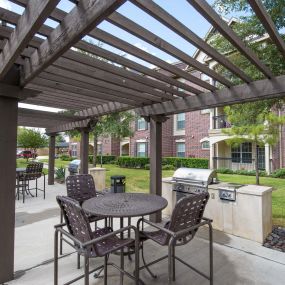 Landscaped courtyards with outdoor grilling and dining areas