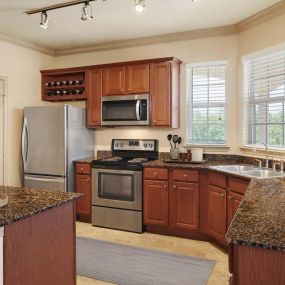 Traditional interiors kitchen with wine rack and stainless steel appliances