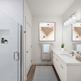 Contemporary Style bathroom with single sink, quartz countertops, hardwood-style flooring, and walk-in shower.
