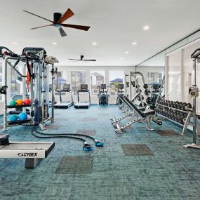 24- hour Fitness Center with rowing machine, cardio equipment, and free weights