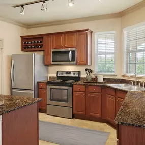 Traditional interiors kitchen with wine rack and stainless steel appliances