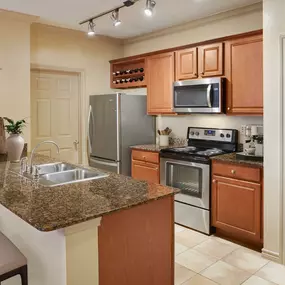 Traditional Style kitchen with bar, granite countertops, and wine rack