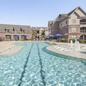 Resort-style pool with lap lane and water features at Camden Cypress Creek Apartments in Cypress, Tx