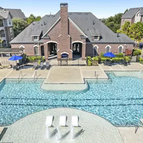 Resort-style pool with water features and sun loungers