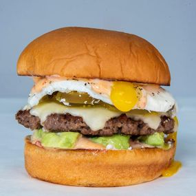 CHIPOTLE AVOCADO BURGER - impossible patty, white american cheese, avocado, pickled jalapeños, cotija cheese, fried egg, chipotle aioli