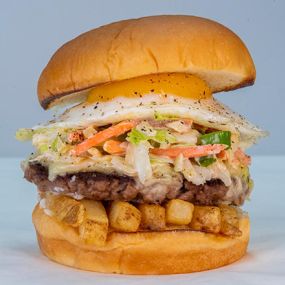 SLAW BURGER - impossible™ patty, white american cheese, fries, haus slaw, fried egg, mayo