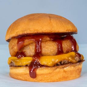 THE ONION BURGER - impossible™ patty, cheddar cheese, onion rings, bbq sauce