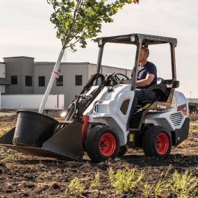 A Bobcat L23 small articulated loader with bucket attachment