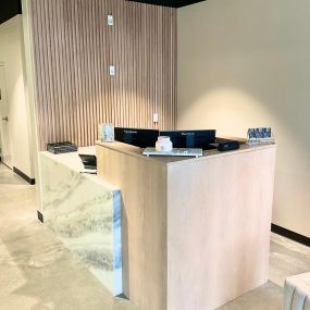White oak slat accent wall and waterfall counters help modernize and add luxurious vibes to any residential or commercial space.