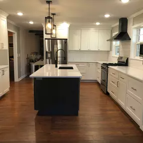 This 1960s Fayetteville kitchen got a total upgrade with maximizing storage and function! Look at that ZLine range hood!