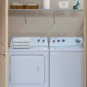 Easy access full-size washer and dryer with shelving
