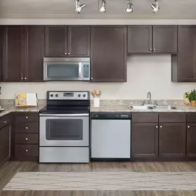 Apartment home kitchen with wood-look tile flooring at Camden Waterford Lakes in Waterford Lakes Florida