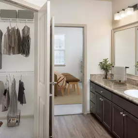 Apartment home bathroom with walk-in closet and spacious countertop space at Camden Waterford Lakes in Orlando Florida