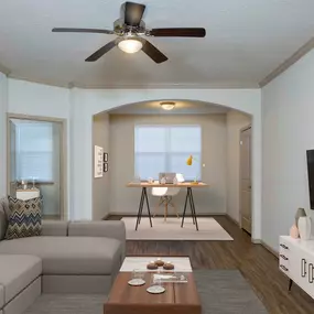 Crown molding and wood inspired flooring in living roomm great home office space in solarium