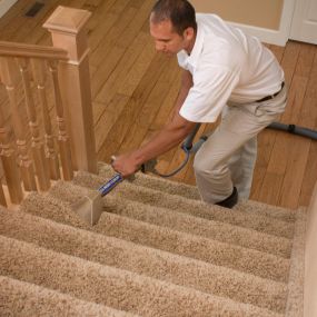 Delta Chem-Dry technician cleaning carpeted stairs