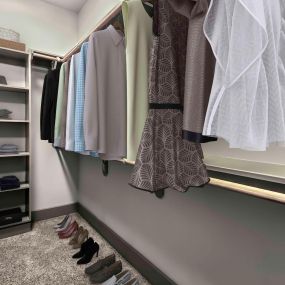Spacious closet with built in wooden shelves