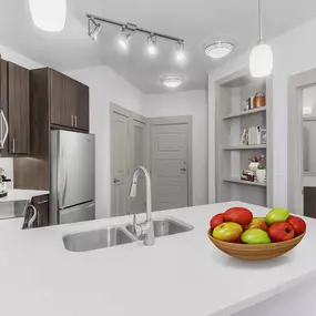 Kitchen with quartz countertop and glass cooktop at Camden Southline