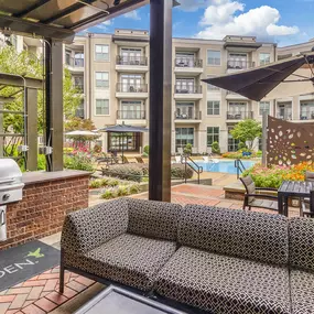 Outdoor entertainment area with BBQ grills next to pool