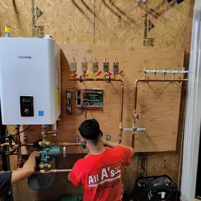 All A's Plumbing and Heating employee Installing a tankless water heater