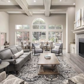 Clubhouse with fireplace and seating at Camden Buckingham apartments in Richardson, TX