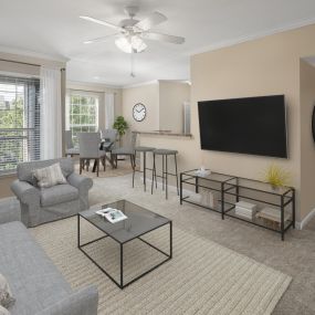 Living room and dining room with carpet at Camden Buckingham apartments in Richardson, Tx