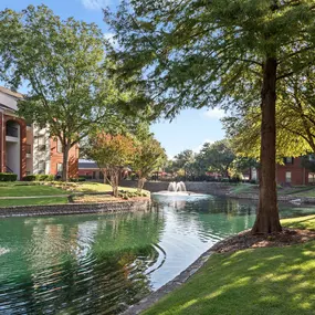 Tree-lined lake with fountains within Camden Buckingham