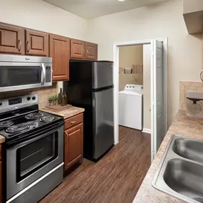 Laundry room with stainless steel appliances and laundry room at Camden Buckingham apartments in Richardson, Tx