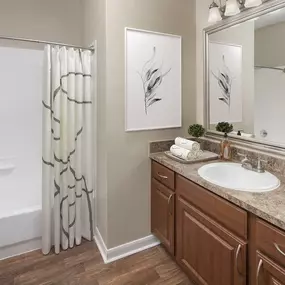 Bathroom with single sink and spacious bathtub at Camden Buckingham