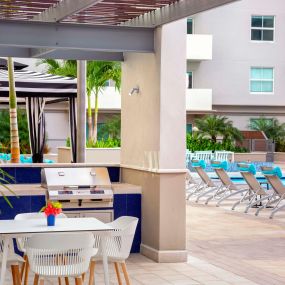 Poolside BBQ grills and dining areas at Camden Brickell apartments in Miami, FL